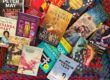 A range of books from Hachette Australia scattered on top of a hand-knitted blanket from Knit4Charities